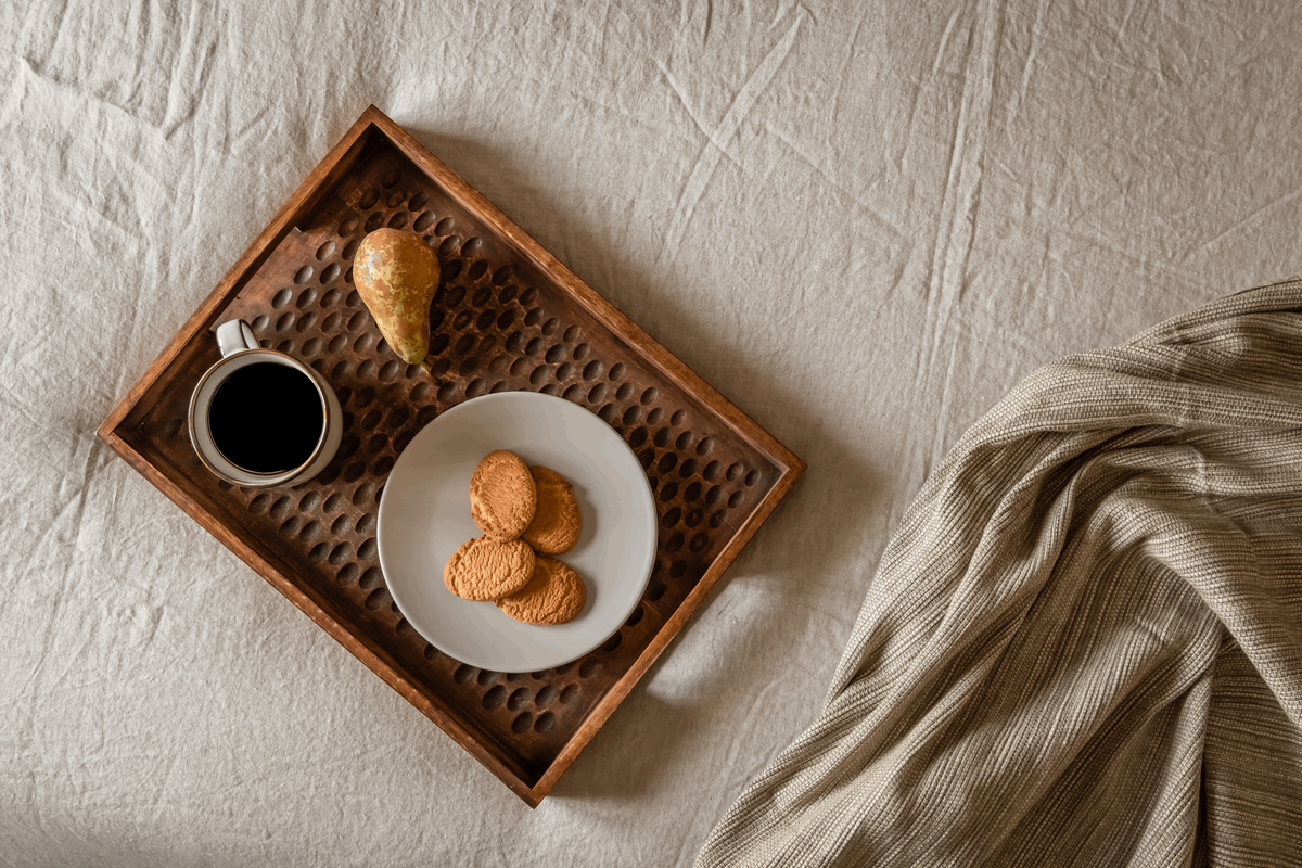 a plate of cookies and a cup of coffee on a bed. Home staging, organic interior design. by Aptó interiors in Barcelona and Amsterdam. Noelle baartmans, Kelly wearstler. Vt Wonen 